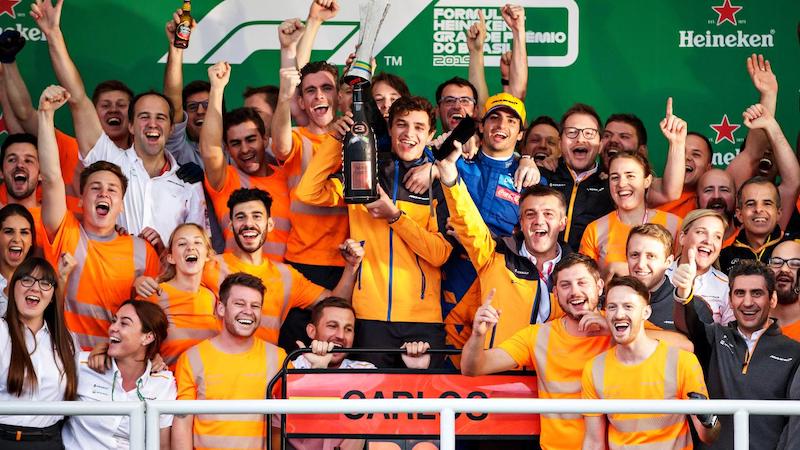 Mclaren team members celebrate the team's surprise podium in Brazil as they endure the team's long road-to-recovery in F1's hybrid-turbo era
