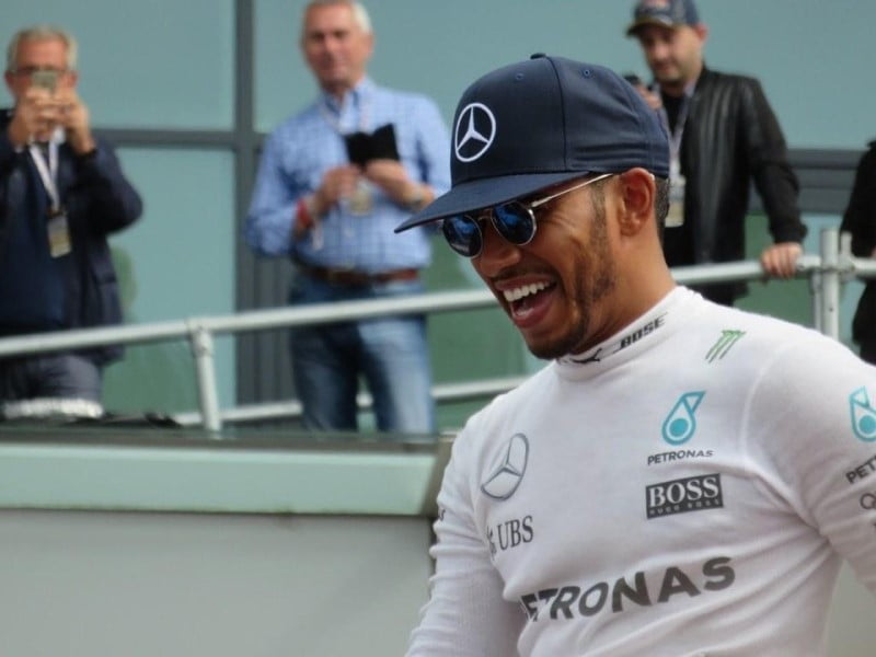 Lewis Hamilton celebrates his achievements as fans and F1 media cheer him on