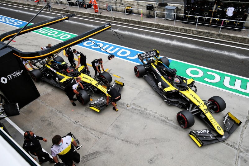 Renault drivers park their cars in the pit lane as the team protests against F1 team alliances in Formula 1