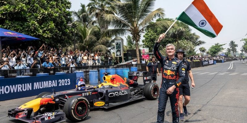 David Coulthard waives the Indian flag during his most-recent Red Bull show car run event in Mumbai, India. The show car event was broadcast in India but Formula 1 races aren't.